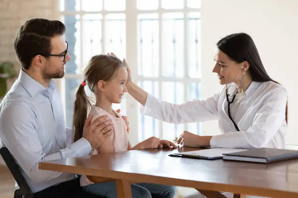Caring female doctor cheer small girl child patient — Stock Photo, Image