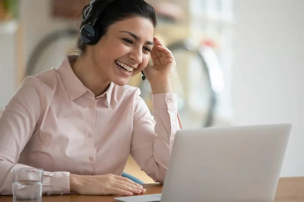 Happy consultant in headphones using laptop for video call — Stock Photo, Image