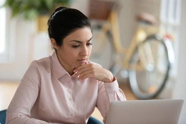 Serious young Indian woman working at computer at home — Stock Photo, Image