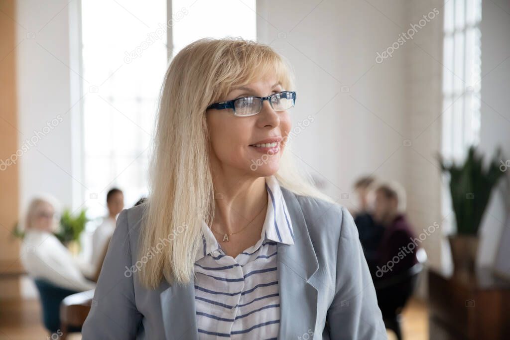 Portrait of middle aged female business team leader