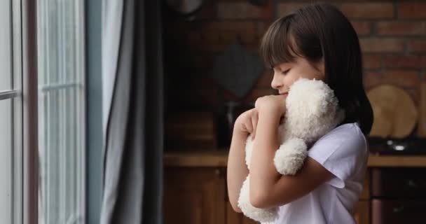Upset lonely little girl hug stuffed toy look into distance — Stock Video