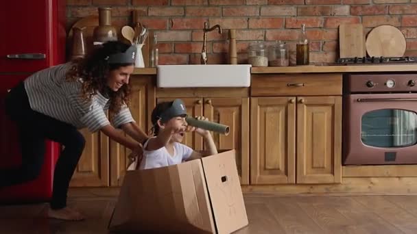Madre e hija juegan juego en acogedora cocina moderna — Vídeo de stock