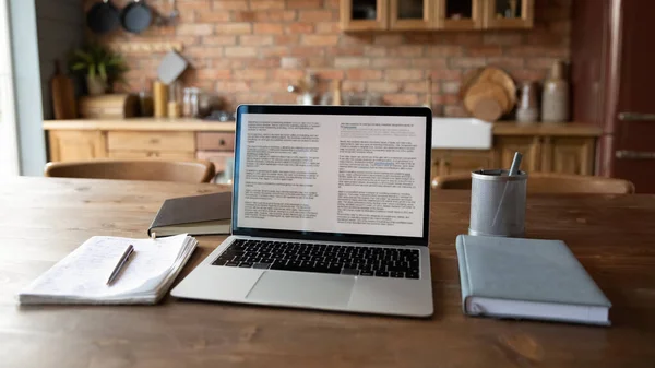 Close up modern laptop standing on wooden table with notebooks — Stock Photo, Image