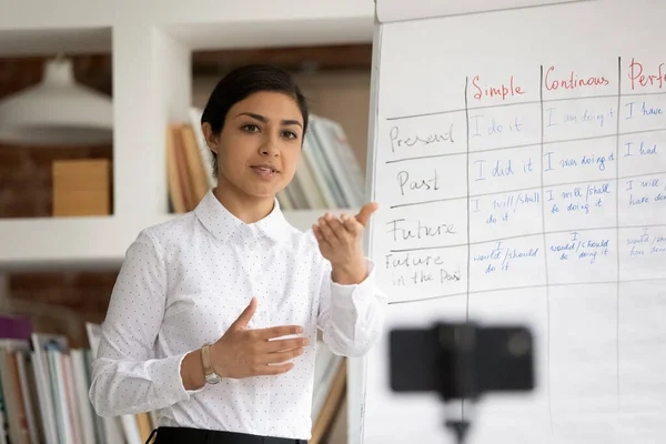 Female Indian teacher have online lesson on cellphone