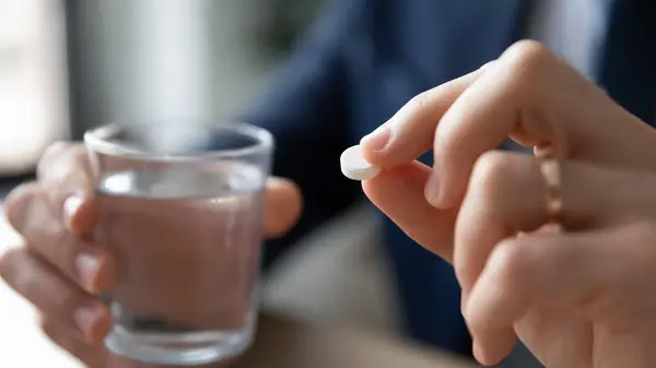 Close up of man take pill and water feeling sick — Stock Photo, Image