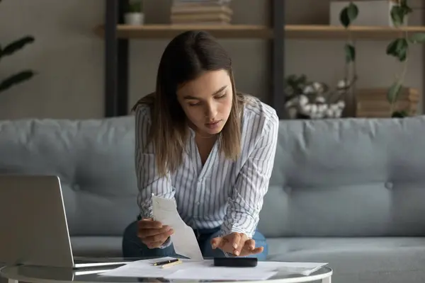 Busy millennial female focused on accounting paperwork at home office — Stock Photo, Image