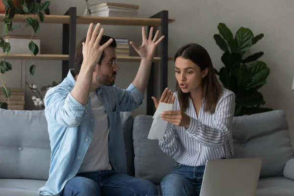 Stressed emotional couple arguing fighting when checking financial papers — Stock Photo, Image