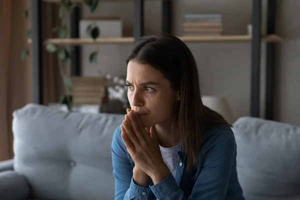 Worried young woman feel fear lean forward with folded hands — Stock Photo, Image