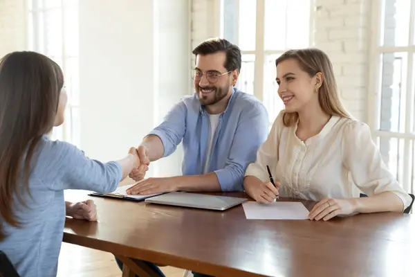 Jóvenes gerentes de recursos humanos sonrientes estrechando la mano con el solicitante de empleo. — Foto de Stock