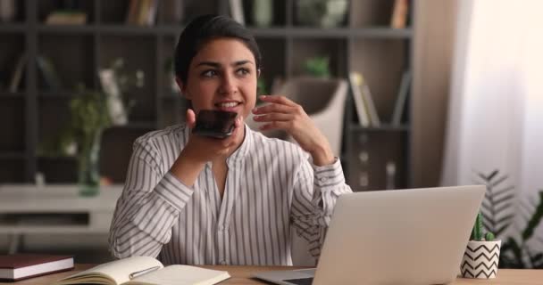 Millennial indian ethnicity woman dictating audio message. — Stock Video