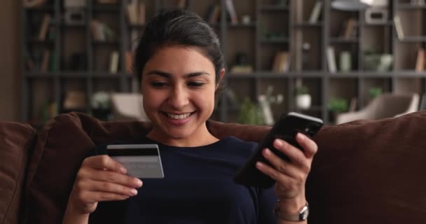 Happy ontspannen jong indisch vrouw genieten van online winkelen. — Stockvideo