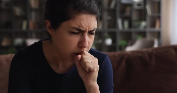 Stressed unhealthy millennial indian woman coughing indoors. — Stock Video