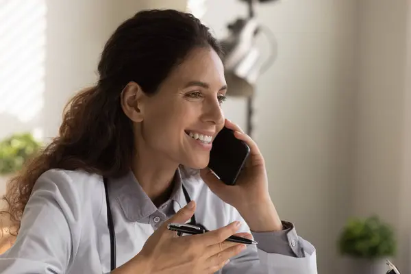 Close up smiling female doctor talking on phone, consulting patient — Stock Photo, Image