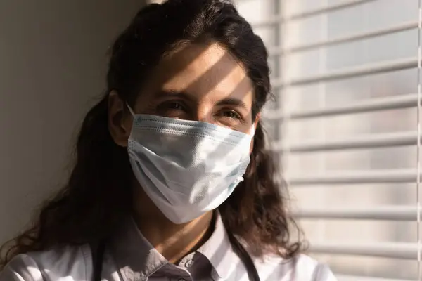 Head shot smiling female doctor wearing protective face mask — Stock Photo, Image
