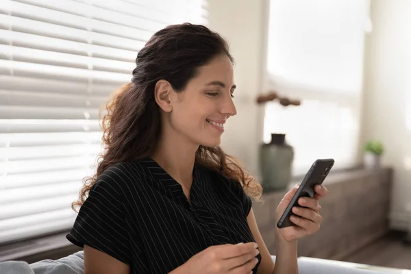 Close up smiling woman looking at phone screen, having fun — Stock Photo, Image