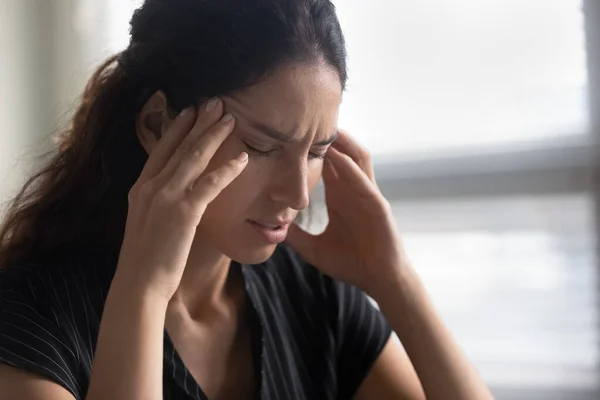 Close up unhappy woman touching temples, suffering from strong headache — Stock Photo, Image