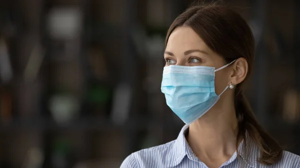 Smiling woman in facemask look in distance dreaming — Stock Photo, Image