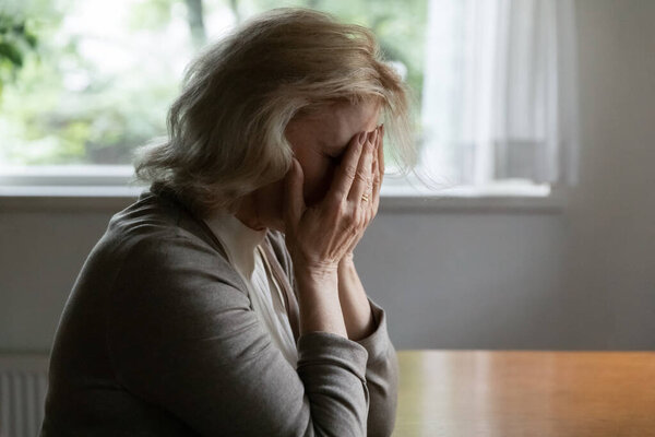 Depressed mature OAP 60s woman going through crisis