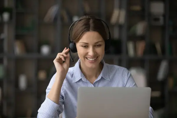 Smiling woman in headphones talk on video call — Stock Photo, Image