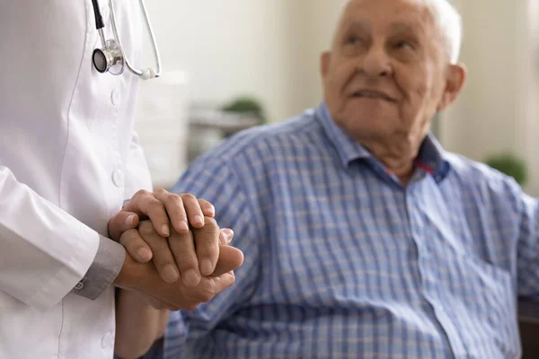 Close up caregiver holding mature man hand, psychological help — Stock Photo, Image