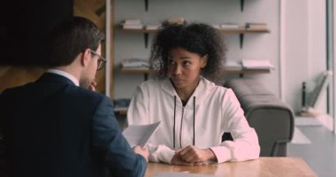 Odaklanmış genç Afrikalı Amerikalı kadın iş görüşmesini geçiyor..