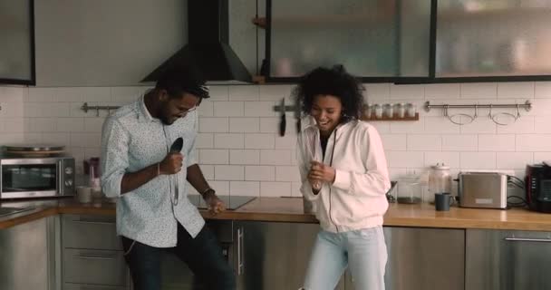 Happy young african american family couple having fun in kitchen. — Stock Video