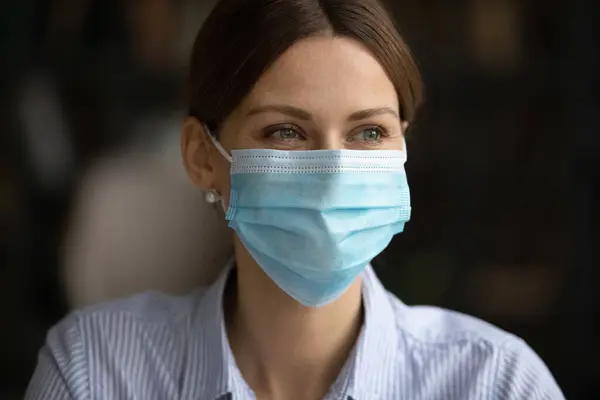 Smiling woman in facial mask protect from covid-19 — Stock Photo, Image