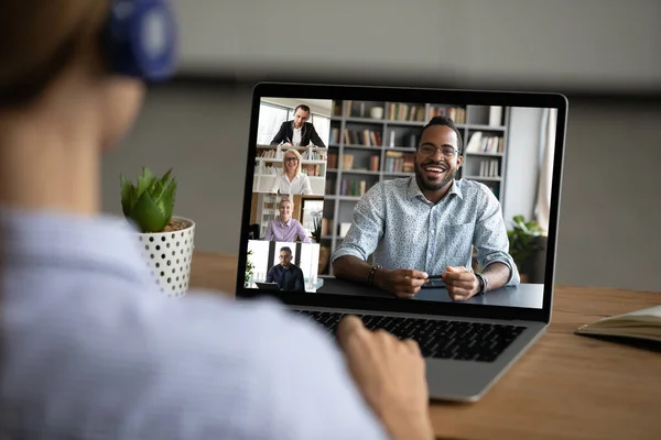 Une employée parle en vidéoconférence avec divers collègues — Photo