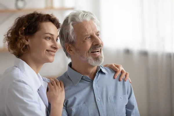 Smiling mature male patient and nurse dream of future — Stock Photo, Image