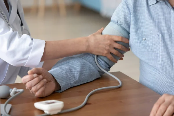 Close up of female nurse measure blood pressure with monitor — Stock Photo, Image