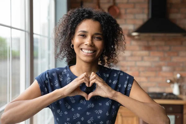 Thankful young african american lady show fingers joined in heart — Stock Photo, Image