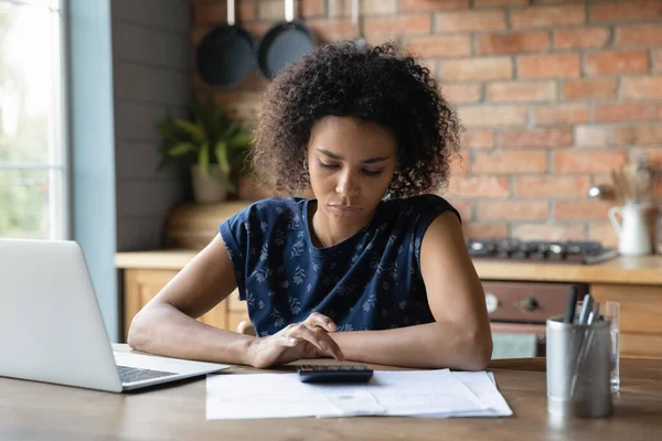 Thoughtful young black woman count tax rate before pay online — Stock Photo, Image