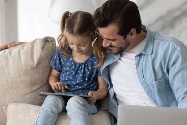 Bakıcı baba ve küçük kız tablet kullanıyor.