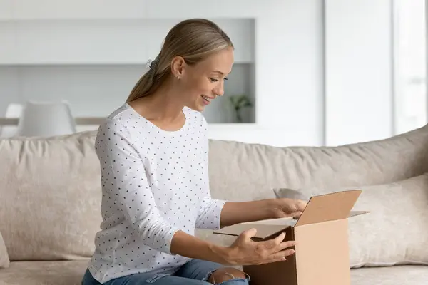 Emocionado mujer caucásica desempacar caja con orden de Internet —  Fotos de Stock