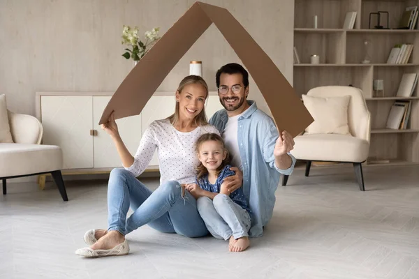 Portrait of happy family with kid celebrate relocation