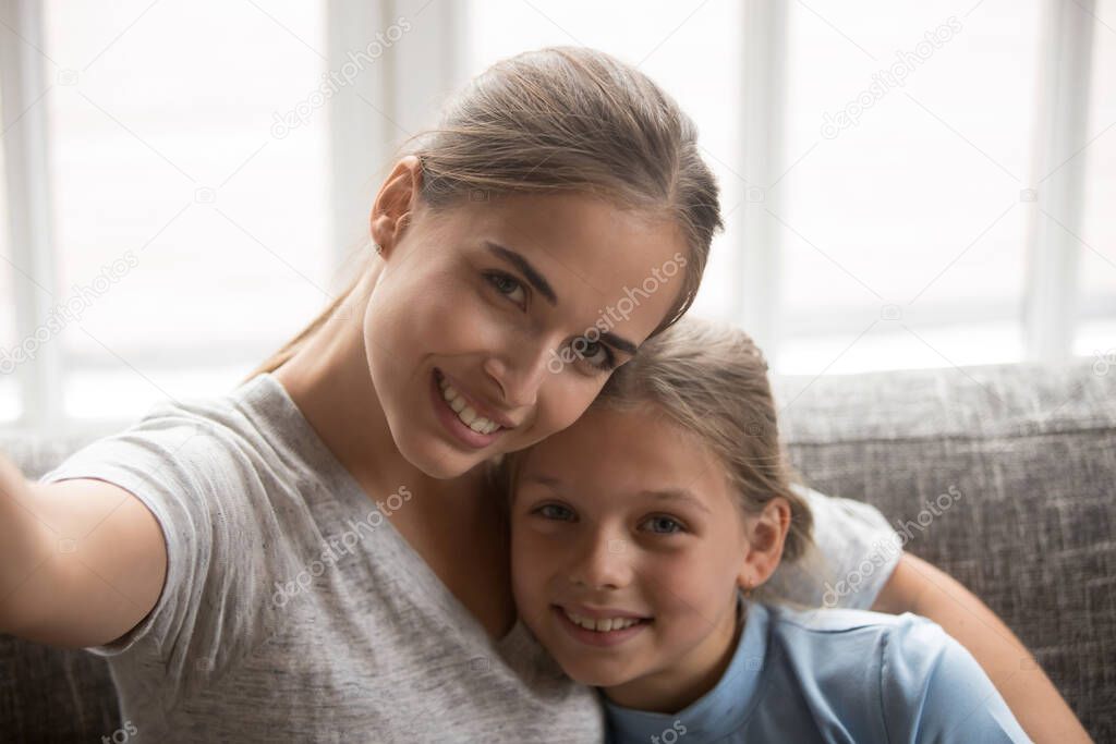 Smiling mother and teen daughter make selfie together