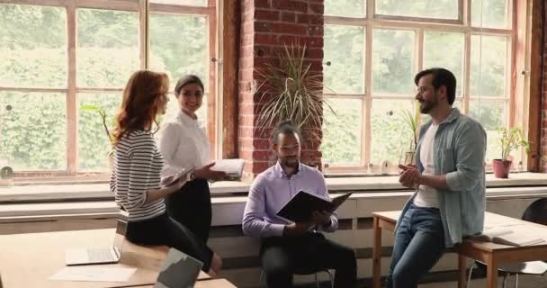 Multiethnische Teamkollegen diskutieren Gemeinschaftsprojekt bei Briefing im Büro — Stockvideo