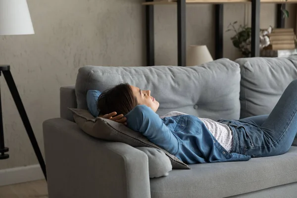 Close up relaxed woman resting, lying on couch at home — Stock Photo, Image