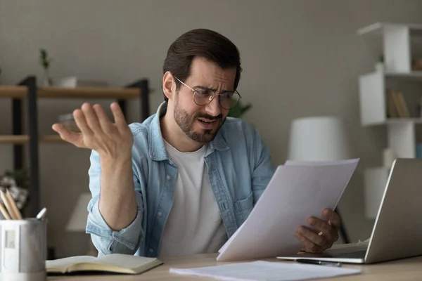 Nahaufnahme unglücklicher unzufriedener Mann mit Brille, der schlechte Nachrichten liest — Stockfoto