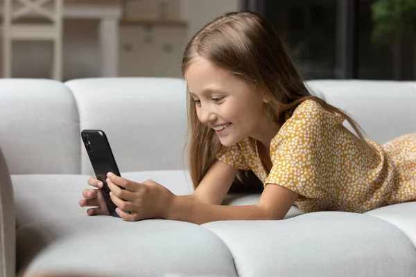 Happy little girl use cellphone talk on video call — Stock Photo, Image