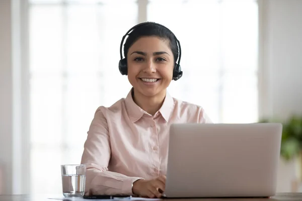 Portrait of smiling Indian female employee at workplace