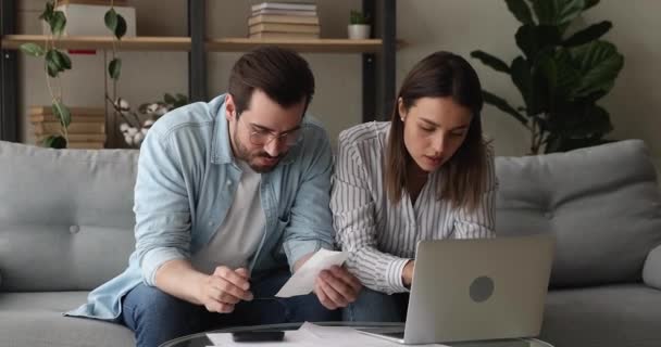 Couple managing family budget calculates and discuss expenses