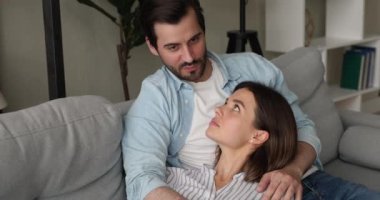 Genç ve sevgi dolu bir çift koltukta dinleniyor ve kaygısızca sohbet ediyorlar.