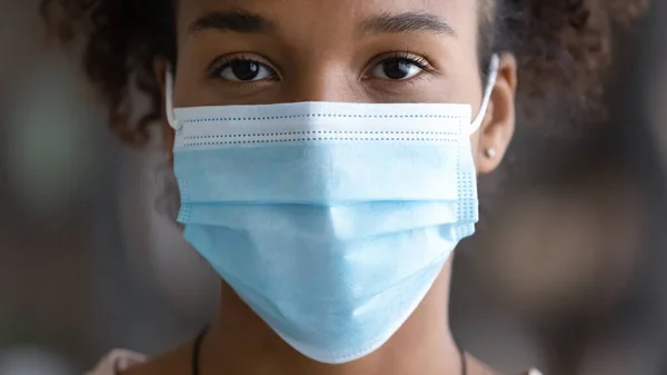 Portrait of African American woman in facial mask — Stok Foto