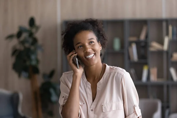 Smiling biracial woman talk on cellphone gadget
