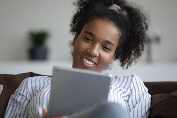 Smiling biracial woman talk on video call on tablet