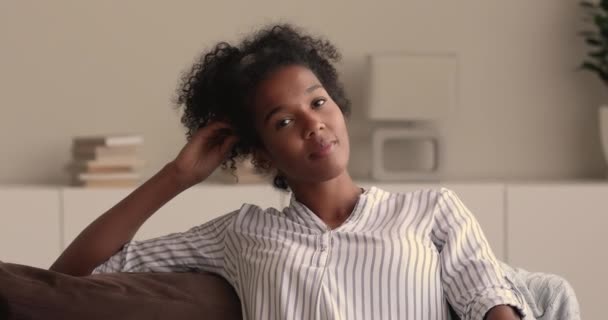Dreamy young african multiracial woman looking at camera. — Stock Video