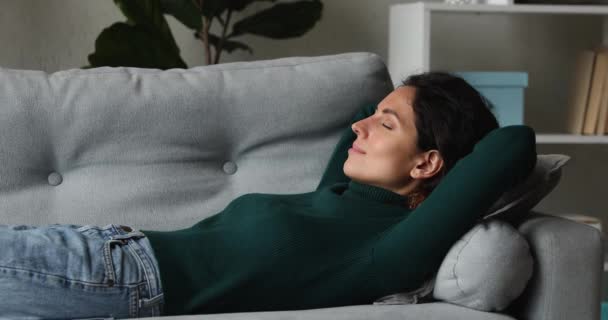 Relaxed young happy woman sleeping on sofa. — Stock Video