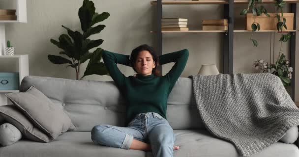 Positive relaxed smiling woman resting on comfortable couch. — Stock Video