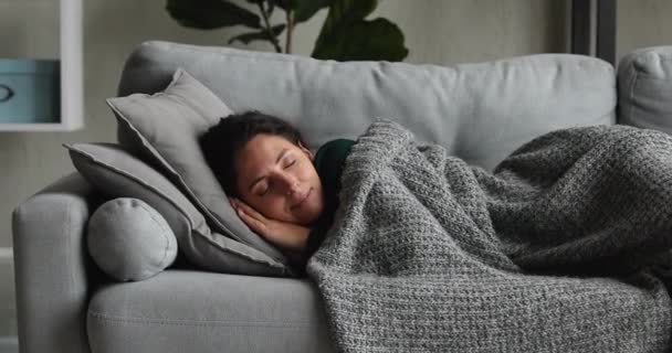 Peaceful young happy woman sleeping on comfortable sofa. — Stock Video